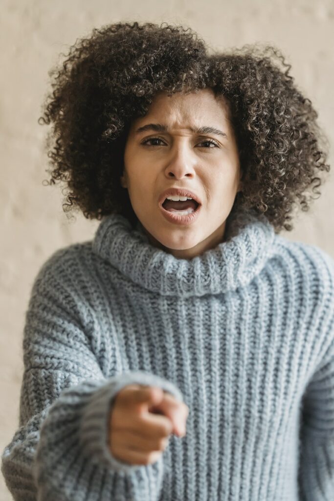 Angry black woman pointing at camera